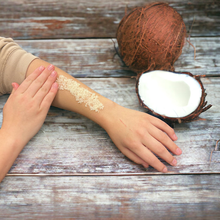 Applying Luxe Lucent Coconut Dead Sea Salt Scrub to the arm