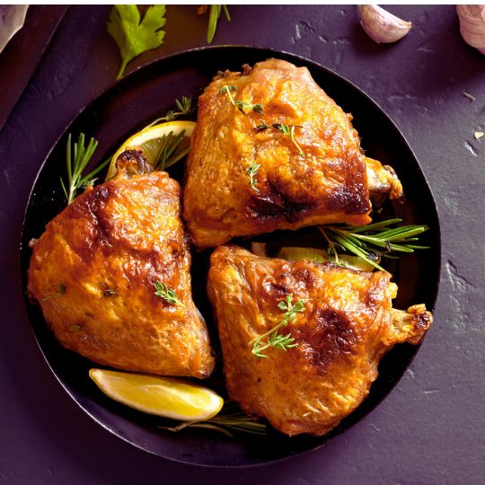 Chicken Thighs on a plate with lemon