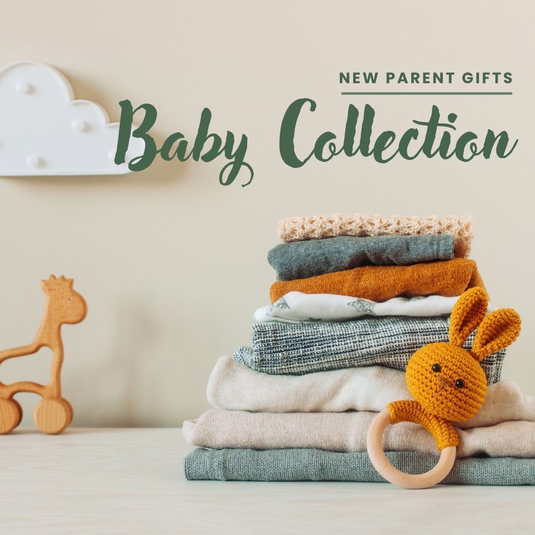 Baby collection gift set with folded blankets, knit clothing, and a handmade bunny rattle — perfect for baby gift baskets, new parent gifts, and baby shower hampers.