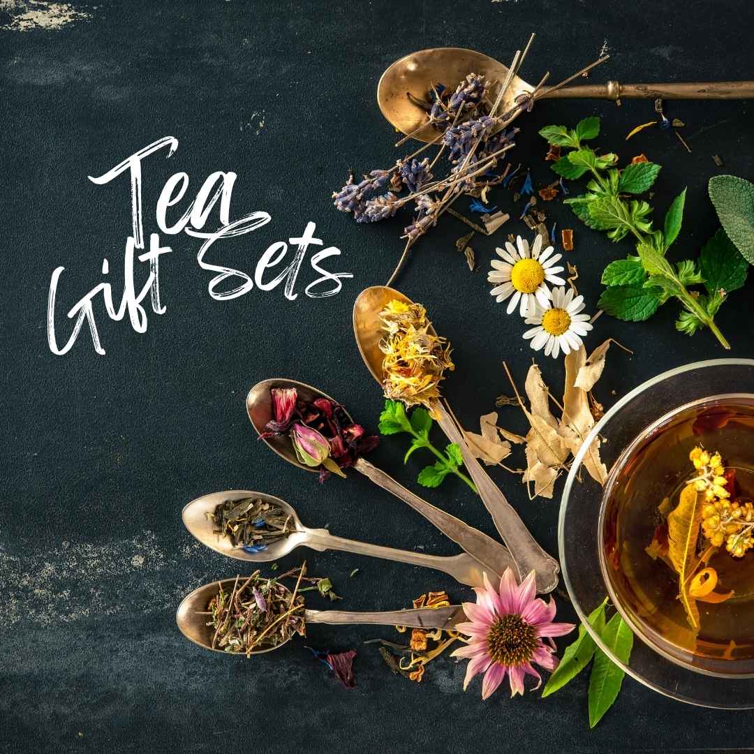 Tea gift sets with herbal loose leaf blends on vintage spoons, including chamomile, lavender, and dried flowers next to a cup of brewed tea.