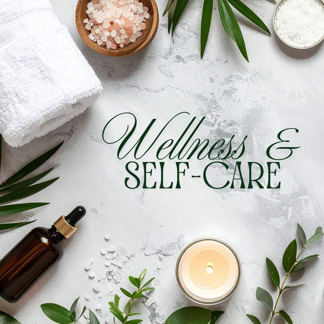 Wellness and self-care gift set with spa essentials including rolled towel, Himalayan salt, aromatherapy candle, and dropper bottle on marble background.