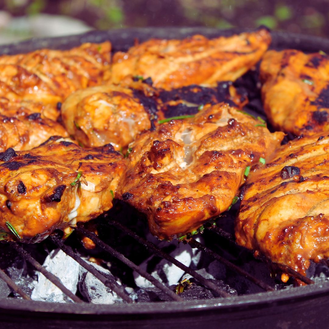 BBQ Chicken on a grill with BBQ sauce