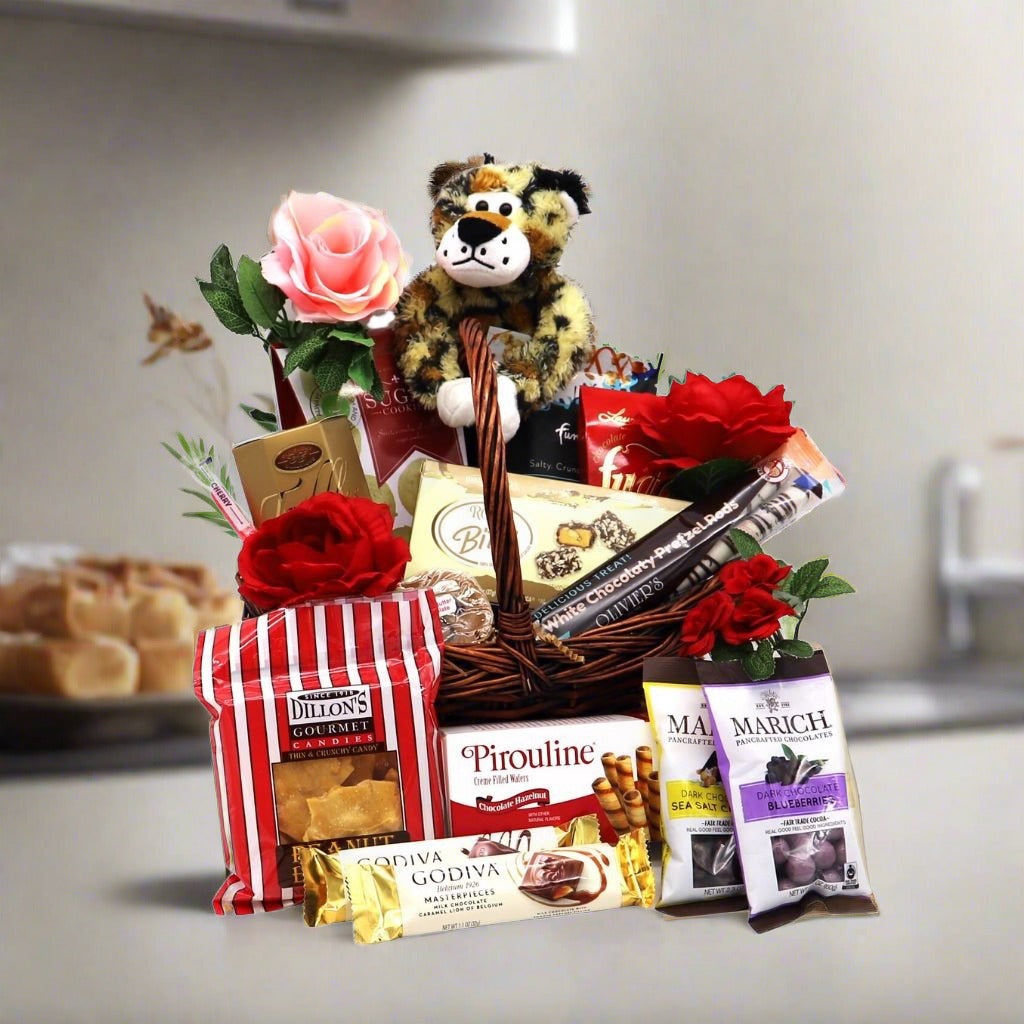 Romantic Valentine’s gift basket featuring a jungle plushie, chocolates, and gourmet treats in a decorative display